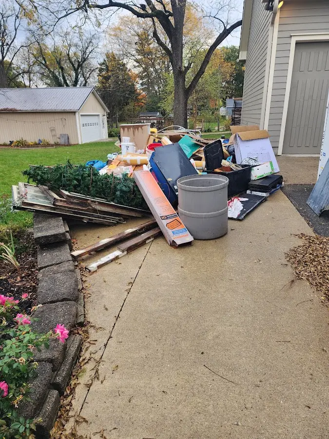 Dumpster being loaded with debris for 12 Yard Dumpster Rental in Monroeville